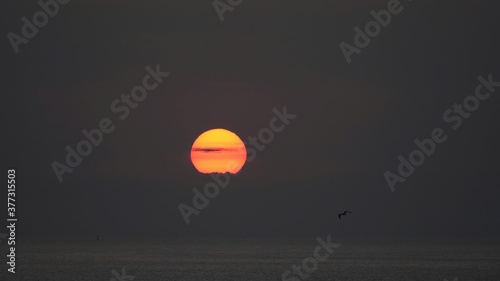 Golden sun lightning on black sky, sunrise landscape © MEDIAIMAG