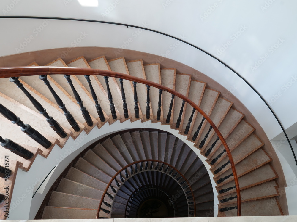Fototapeta premium Spiral stairs down view, classic and modern architecture