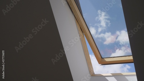 white cloud move on blue sky seen from open wooden attic widow    fresh air in house  fast motion