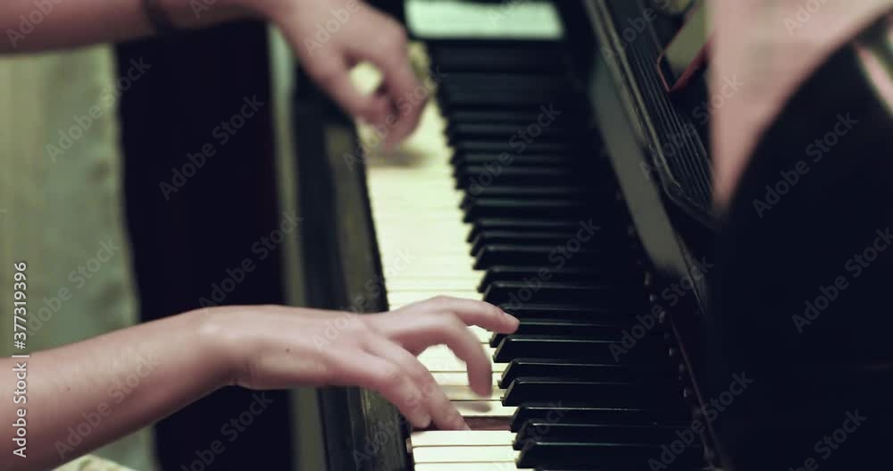 Portrait side view how girl hands playing on the piano and singing Portrait side view how girl hands playing on the piano and singing