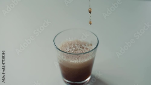 Soda fizzy cold drink in a glass close-up white background.