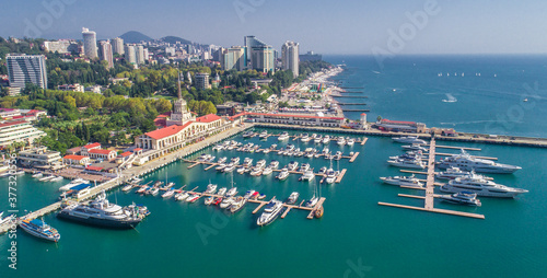 Aerial photography. The black sea coast of Russia, the city of Sochi, seaport, yachts and ships at the pier. City attraction