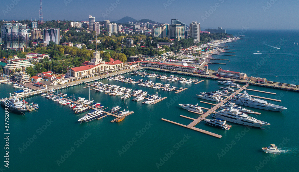 Obraz premium Aerial photography. The black sea coast of Russia, the city of Sochi, seaport, yachts and ships at the pier. City attraction