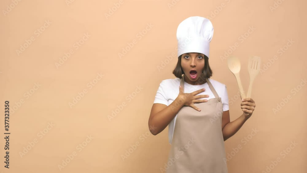 Young cook indian woman pointing to the side Young cook indian woman pointing to the side