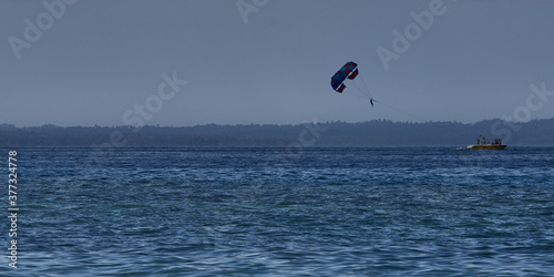 Parasailing in full enthusiasm in a boat with Indian national flag.