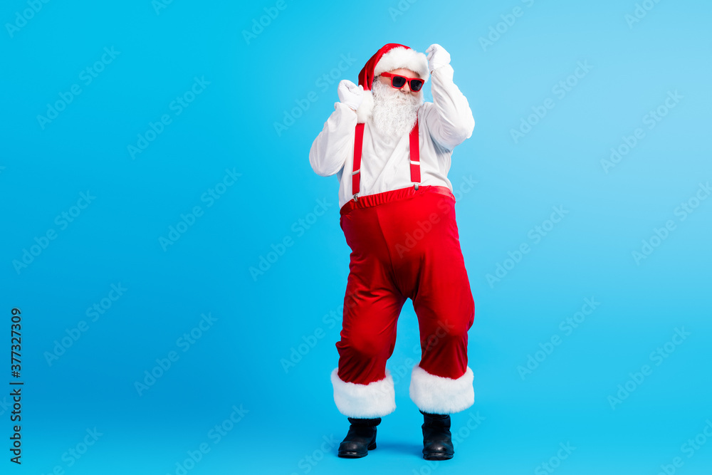Full size photo of cool hipster santa claus dance x-mas christmas jolly  holly discotheque wear suspenders sunglass overalls boots isolated over  blue color background Stock Photo | Adobe Stock