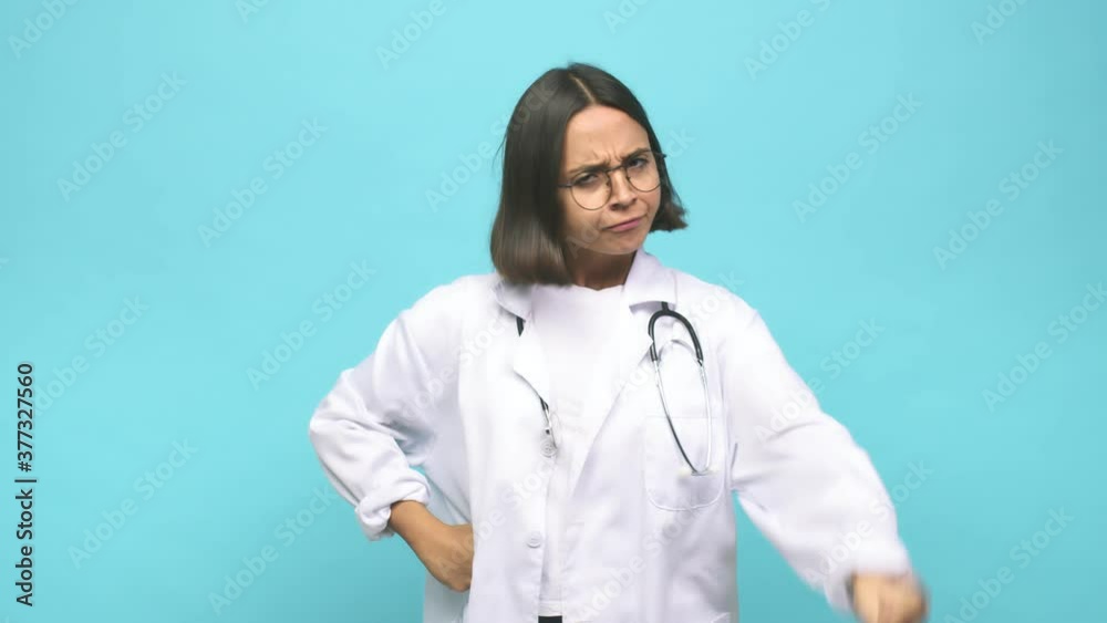 Young doctor indian woman showing fist to camera, aggressive facial expression Young doctor indian woman showing fist to camera, aggressive facial expression