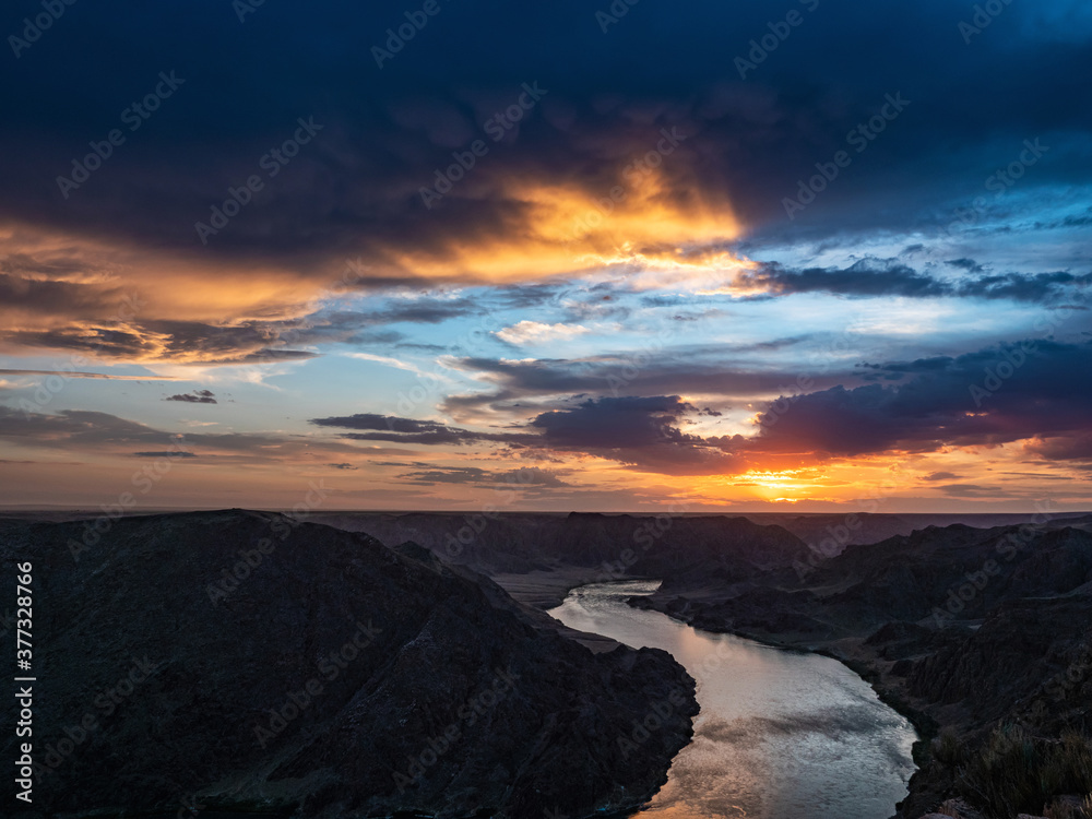 Beautiful sunset on the river. Ili River in spring. Kazakhstan. Almaty Region