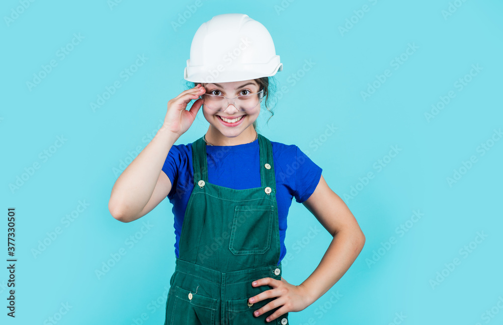 foreman teen child. kid work in helmet. little girl in a helmet. girl making repairs. teen dressed in hard hat. concept of childhood development. girl in helmet is construction worker