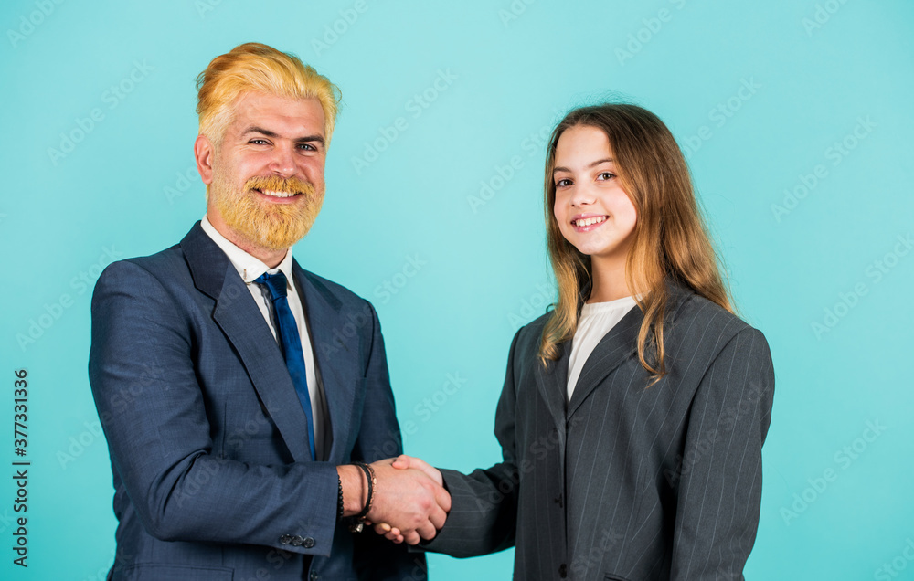 Luxury and success. partnership. teamwork of daughter and dad. business meeting. modern office life. businessman dyed blond hair. small girl in oversized suit jacket. future career. family business Luxury and success. partnership. teamwork of daughter and dad. business meeting. modern office life. businessman dyed blond hair. small girl in oversized suit jacket. future career. family business
