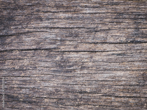 The old wood surface is rough and uneven.