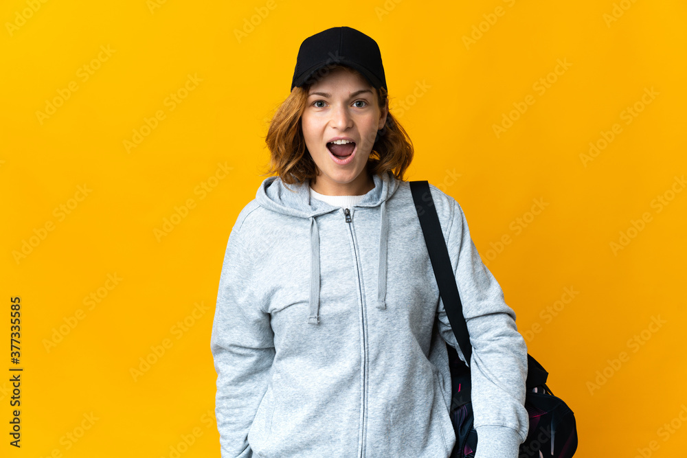 Young sport Georgian woman with sport bag over isolated background with surprise facial expression Young sport Georgian woman with sport bag over isolated background with surprise facial expression