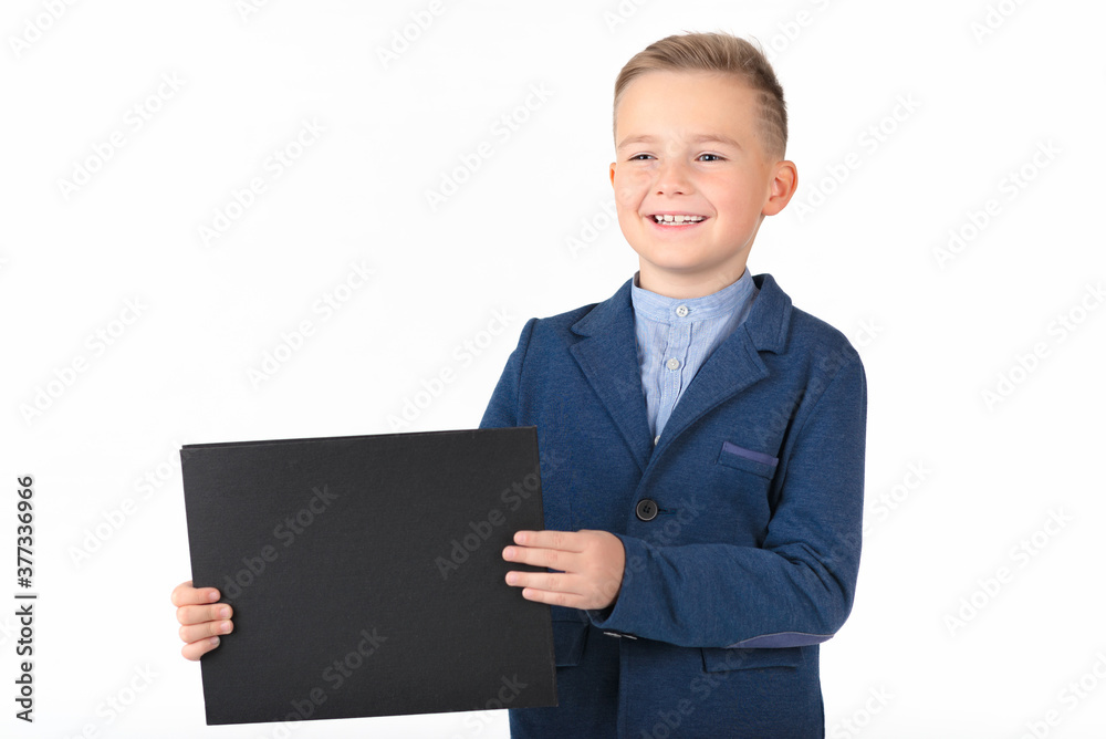 Happy exited caucasian young boy showing and displaying blank black board ready for your text or product. Happy exited caucasian young boy showing and displaying blank black board ready for your text or product.