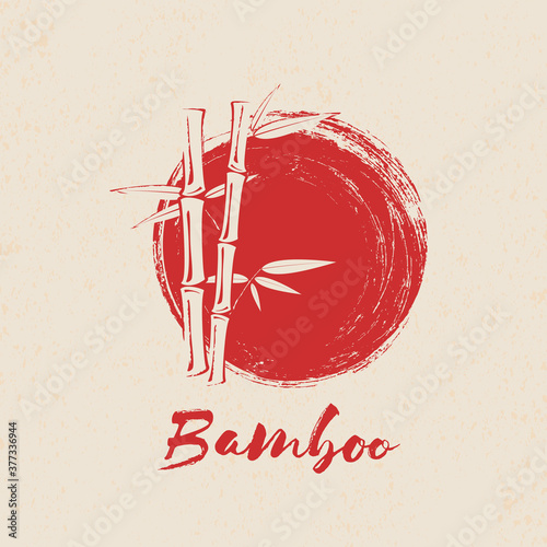 Bamboo tree and leaves on red grunge circle background.