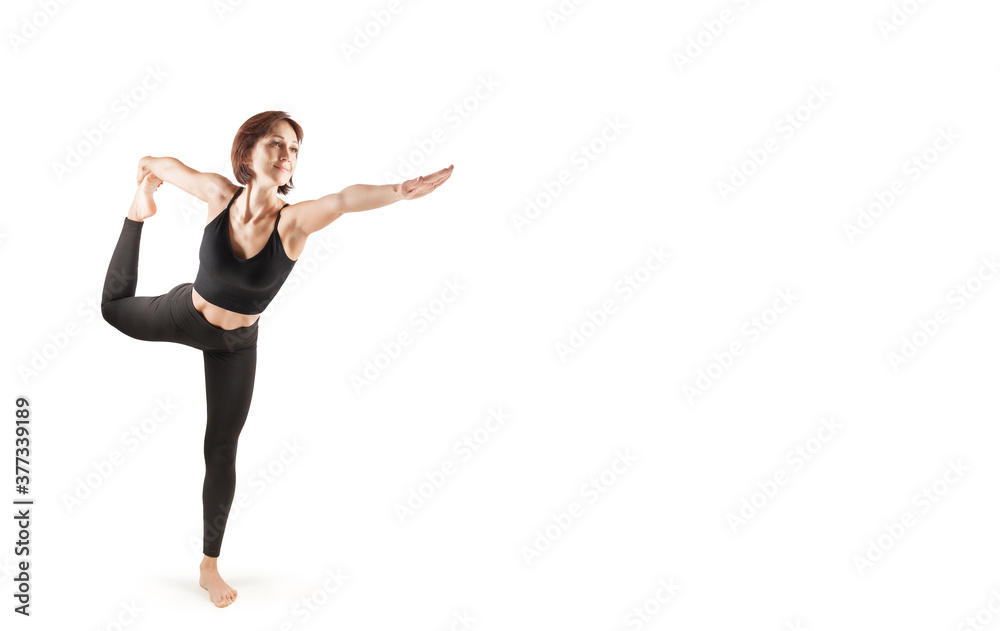 young beautiful woman in black leggings and top doing fitness indoors, on a white background, isolate young beautiful woman in black leggings and top doing fitness indoors, on a white background, isolate