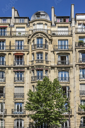 Architecture of Paris: Old French house with traditional balconies and windows. Paris, France.