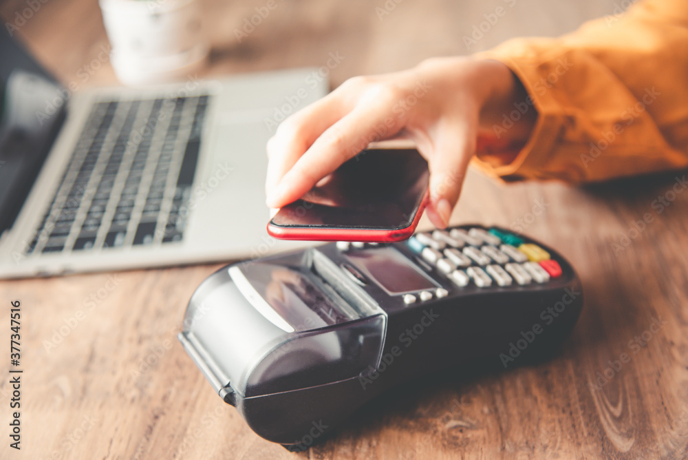 Payment with NFC technology by mobile phone. Modern cashless payments. Payment with NFC technology by mobile phone. Modern cashless payments.