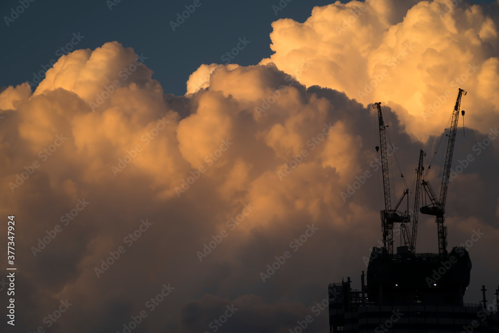 Sunset storm clouds and industrial cranes at Istanbul Turkey