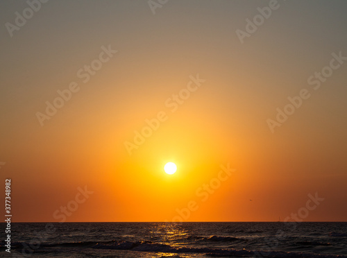 Romantic sunset by the sea. The setting sun over the waves. © Inveru