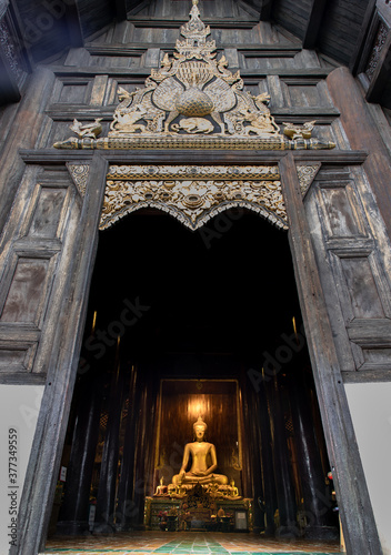 Chiangmai, Thailand - Sep 07, 2020 : The buddha image in main vihan at wat phun tao. Wat phan tao is a beautiful wooden temple in chiang mai. Selective focus. photo