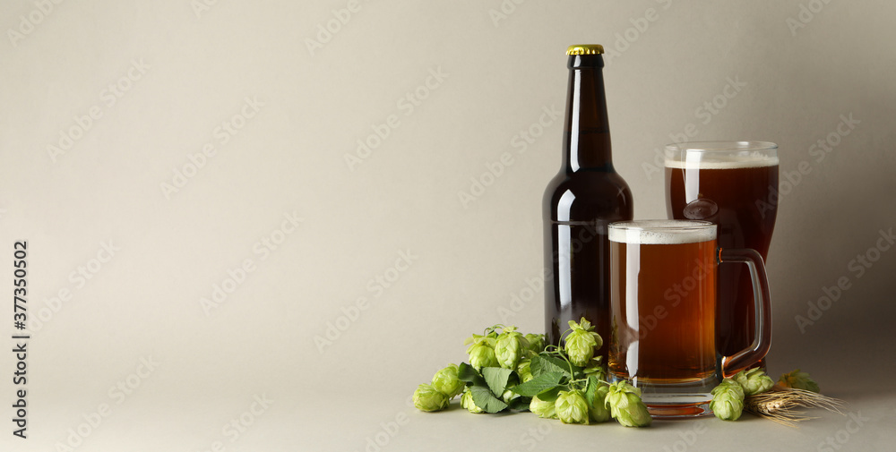Beer and green hop on gray background Beer and green hop on gray background