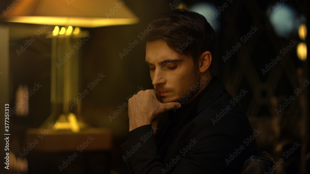 Focused top manager pondering in chair indoors. Serious man touching chin. Focused top manager pondering in chair indoors. Serious man touching chin.