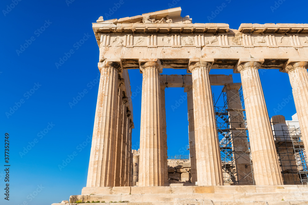 The Parthenon temple in the Acropolis of Athens against the blue sky, Greece.