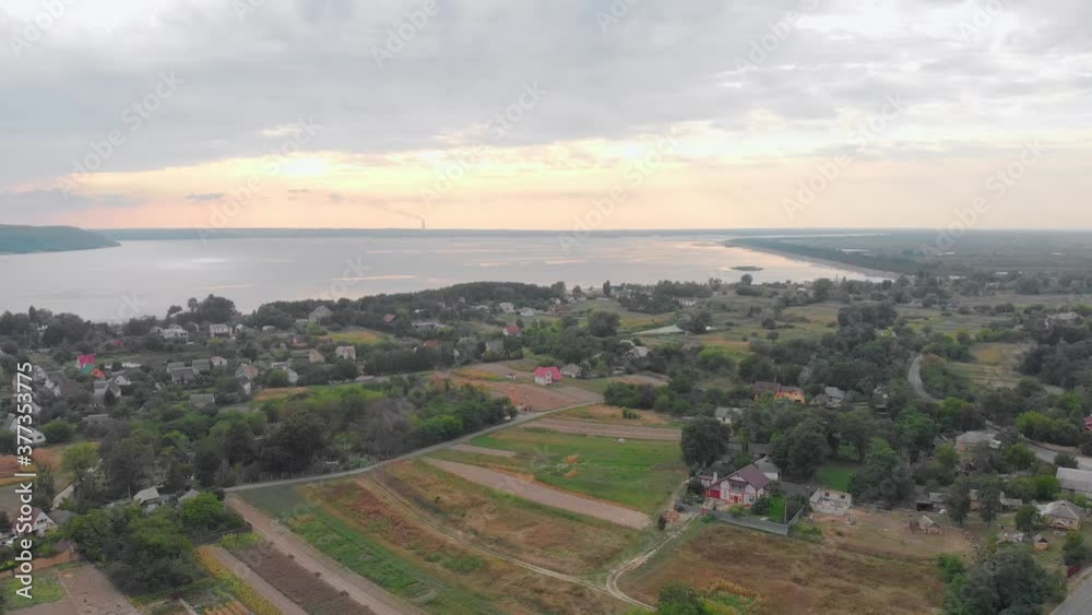 Sunset river and suburb private houses on the shore aerial drone backward push out camera movement Sunset river and suburb private houses on the shore aerial drone backward push out camera movement