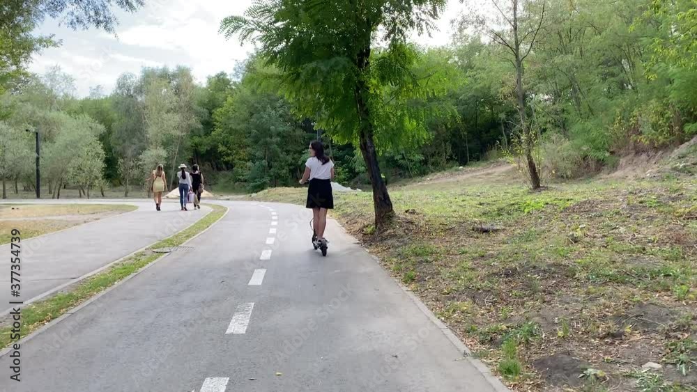 custom made wallpaper toronto digitalHipster woman riding on Electric Scooter on the special bicycle line in the park environment