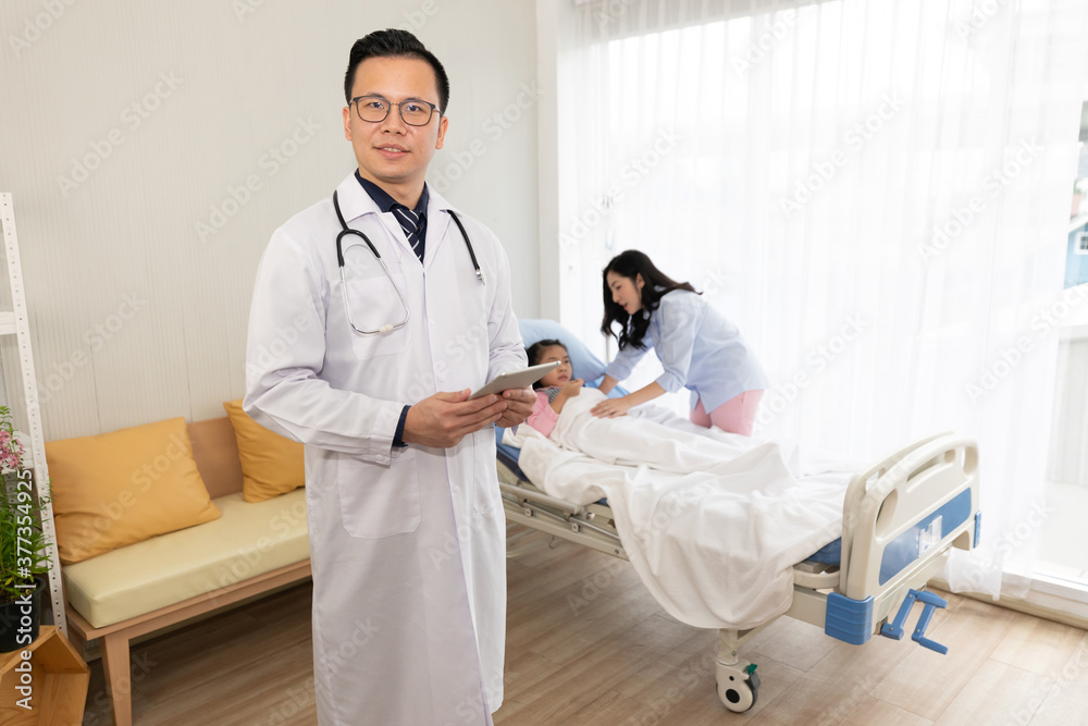 portrait doctor holding tablet and finding a patient’s information in hospital portrait doctor holding tablet and finding a patient’s information in hospital