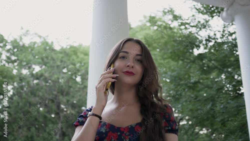 close up portrait young woman who is talking on mobile phone outdoor close up portrait young woman who is talking on mobile phone outdoor