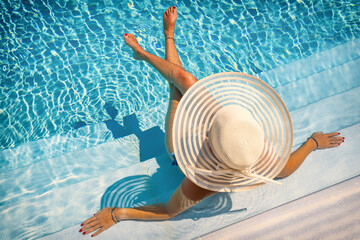 woman in luxury spa resort near the swimming pool.