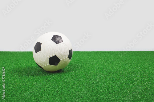 Soccer ball on green turf. Football game or school class concept. Copy space banner