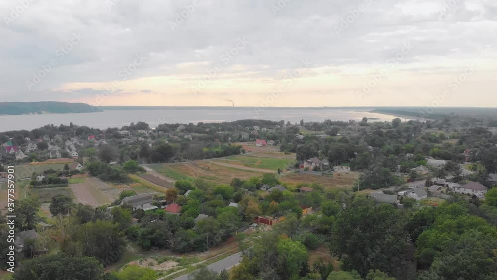Village suburb and river aerial drone left side camera movement Village suburb and river aerial drone left side camera movement