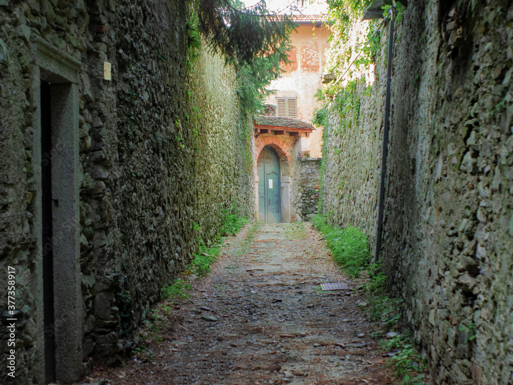 A quaint narrow medieval lane leads to the entrance of a beautiful country house
