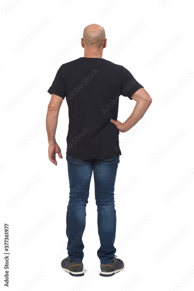 Fototapeta premium rear view of a bald man on white background, hand on hip