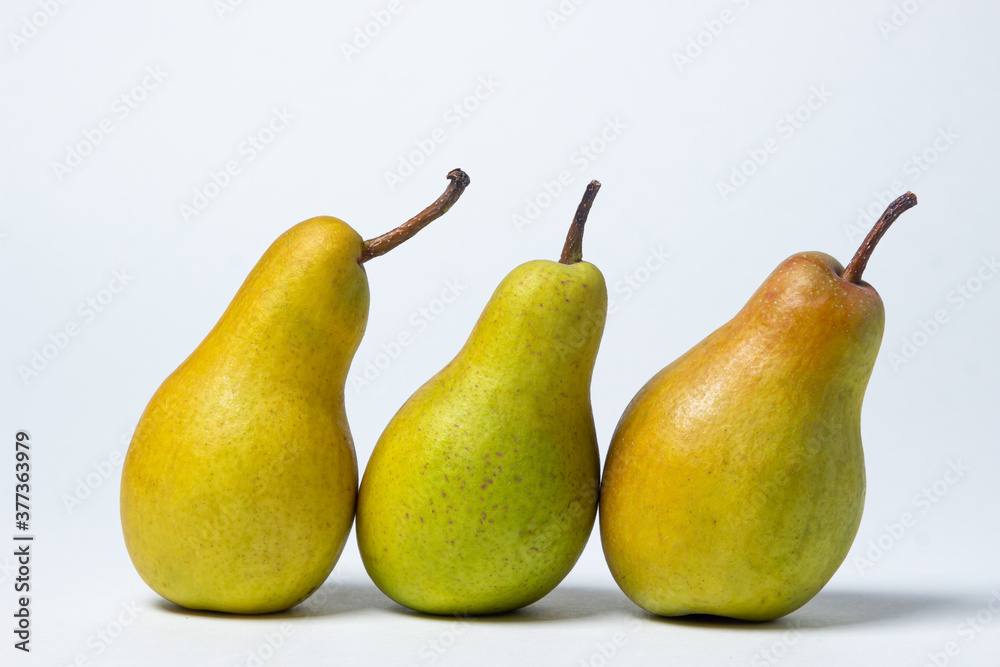 Pears on a white background. Three pears lie next to each other. Healthy fruits Pears on a white background. Three pears lie next to each other. Healthy fruits