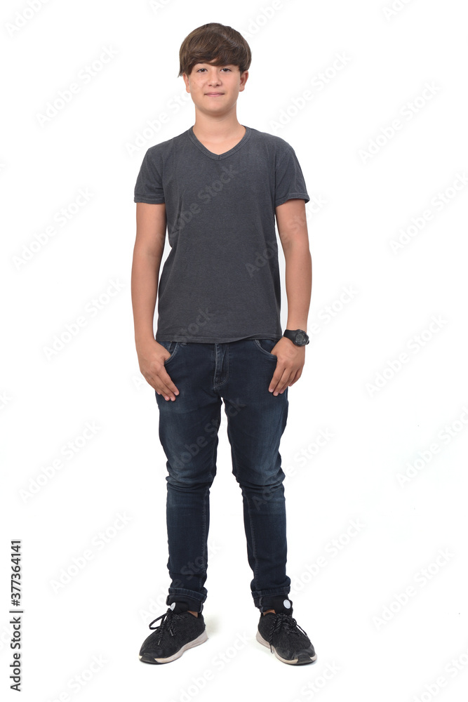 portrait of a teenage boy on white background with hands in pockets portrait of a teenage boy on white background with hands in pockets