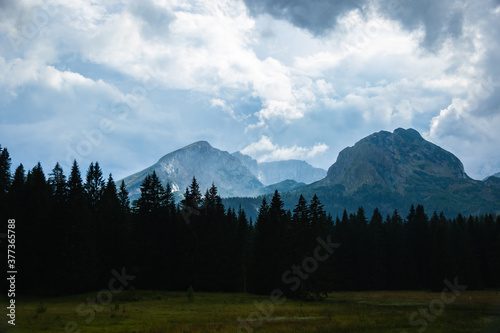 High peaks against the background of forests, mountains in clear weather after rain, nature and clouds in Montenegro