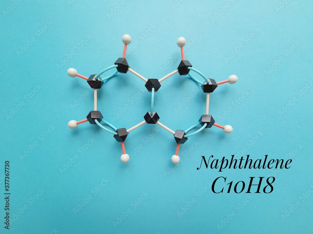 Molecular structure model and chemical formula of naphthalene molecule. Naphthalene is an
