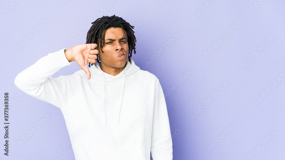 Young african american rasta man showing thumb down, disappointment concept. Young african american rasta man showing thumb down, disappointment concept.