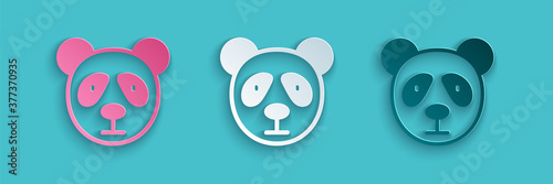 Paper cut Cute panda face icon isolated on blue background. Animal symbol. Paper art style. Vector.
