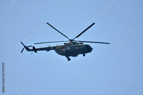 Fototapeta Naklejka Na Ścianę i Meble -  Helicopter flies across the sky
