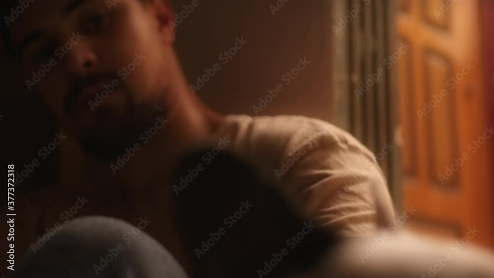 Handsome young man is lean against the wall and he love his dog. Cinematic look Handsome young man is lean against the wall and he love his dog. Cinematic look