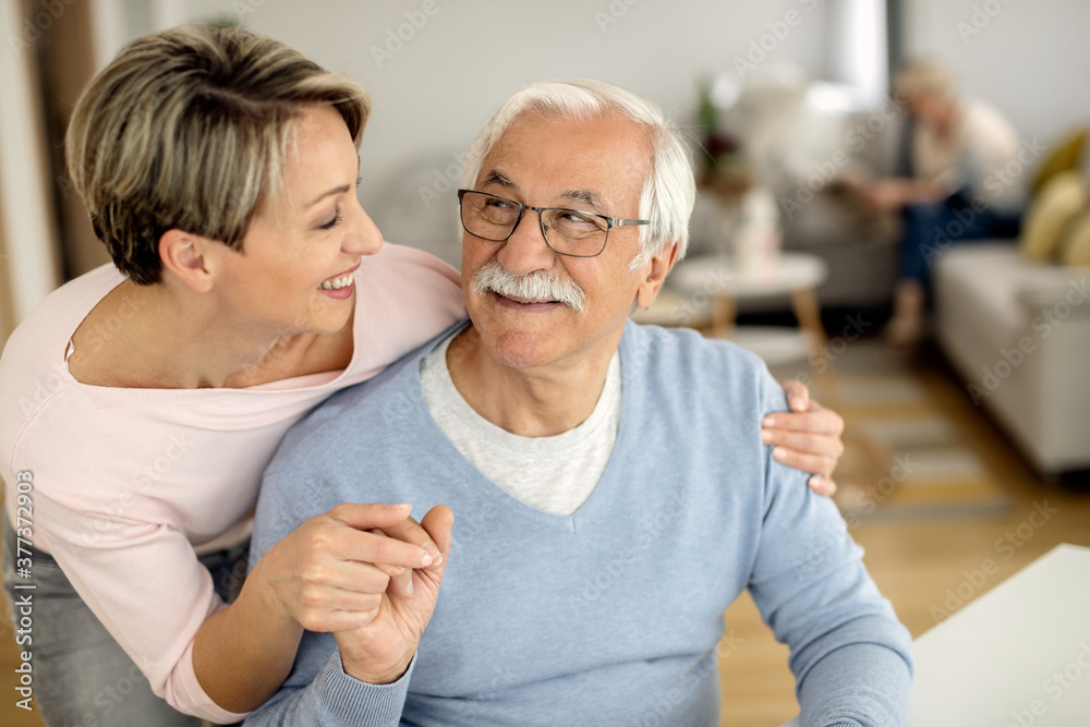 Happy mature father and is adult daughter talking at home. Happy mature father and is adult daughter talking at home.