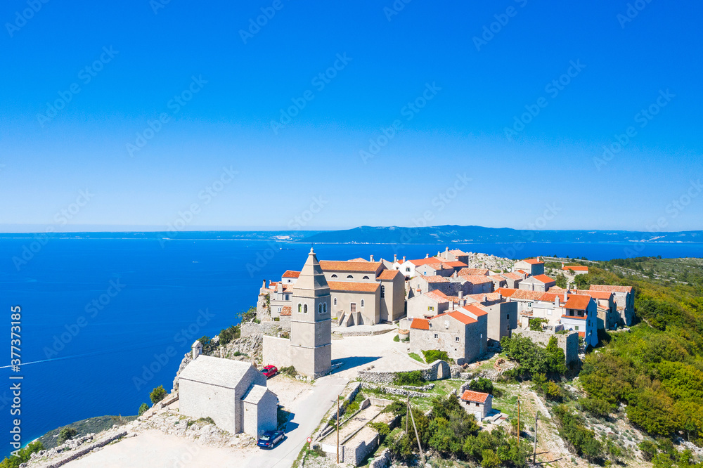 Amazing historic town of Lubenice on the high cliff, Cres island in Croatia, Adriatic sea in background
