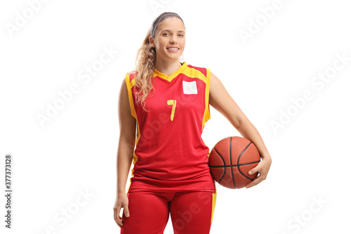 Female basketball player posing with a ball under arm