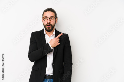 Young caucasian business man isolated on a white background pointing to the side