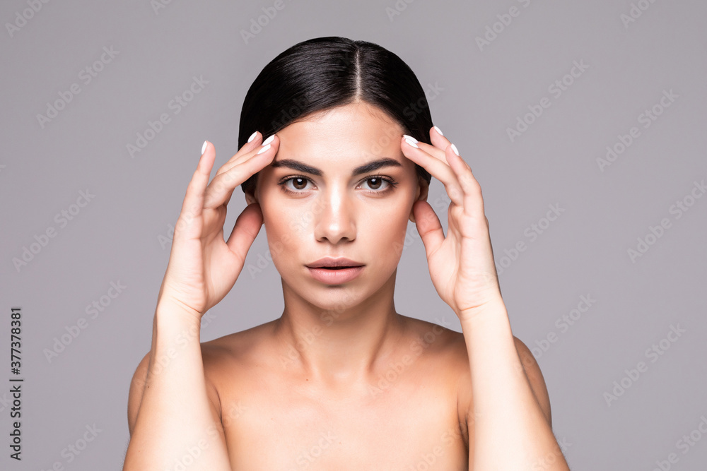 Young pretty woman with beauty skin isolated over gray background