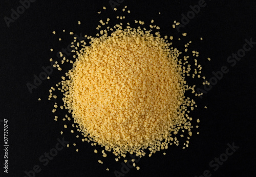 Bild auf Leinwand Heap of dry couscous isolated on black background